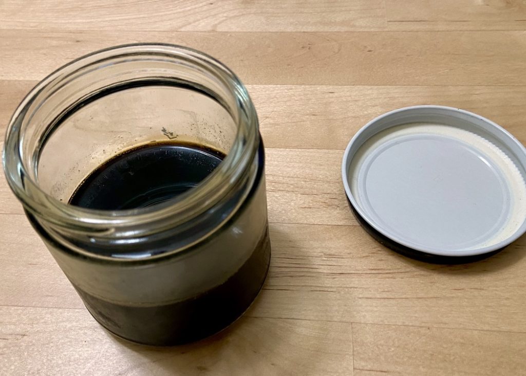 open jar of black sugar syrup