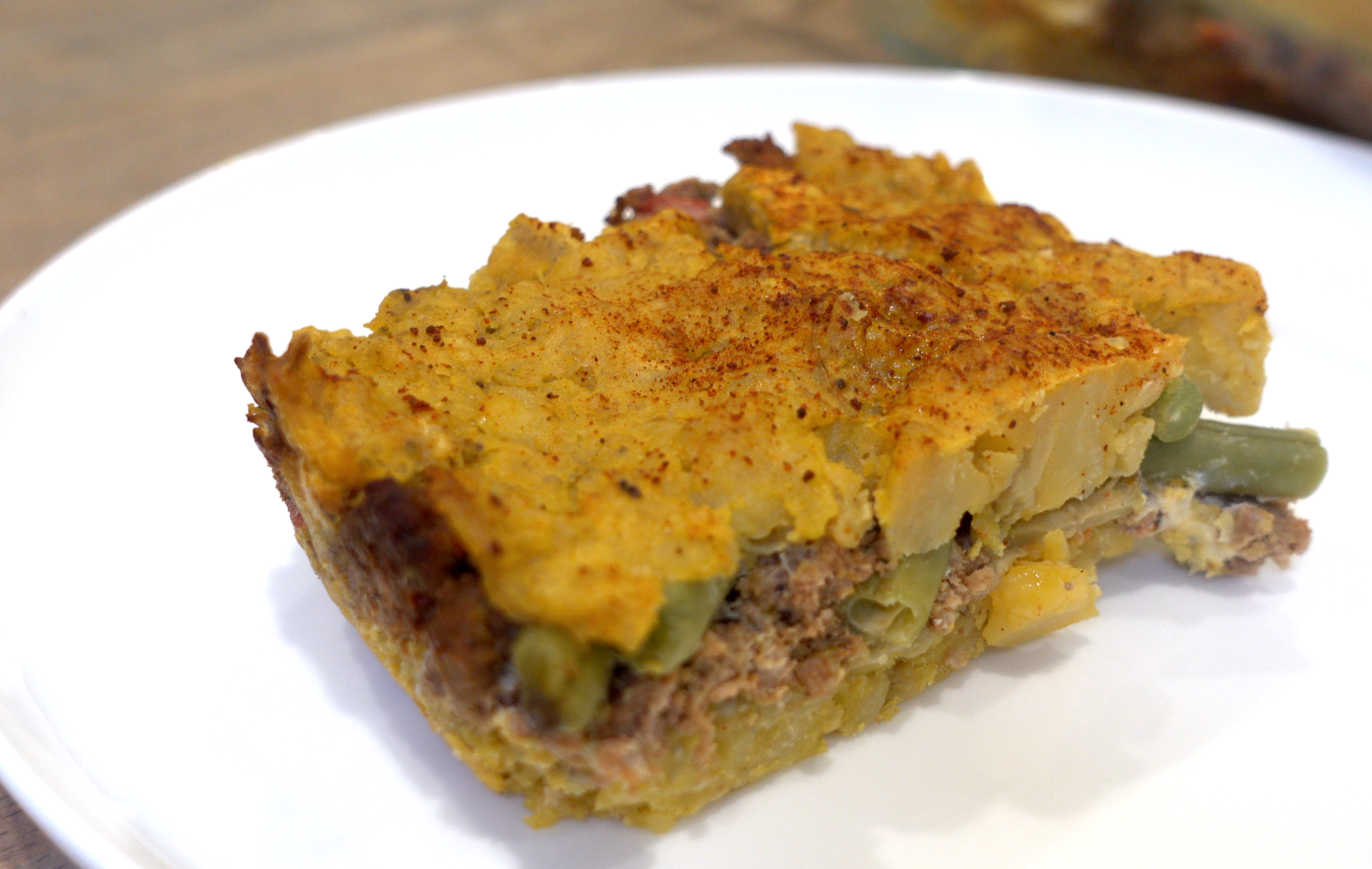 Rectangular slice of Pastelon served on a white plate